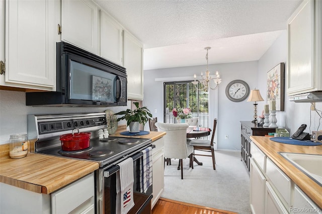 60 S Moline St, Aurora, CO 80012 - kitchen featuring electric stove, black microwave, white cabinets, a chandelier, and butcher block countertops