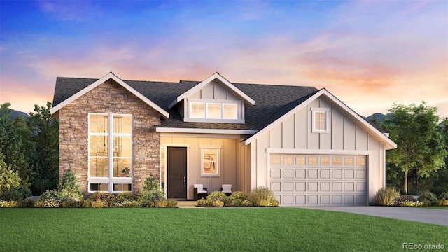 view of front of house with an attached garage, driveway, stone siding, a front lawn, and board and batten siding