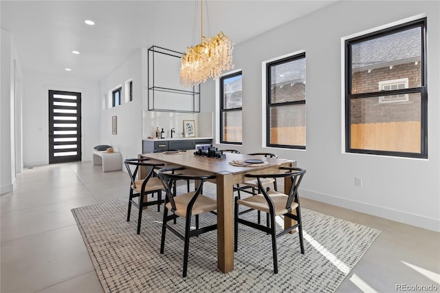 dining space featuring a chandelier and a healthy amount of sunlight