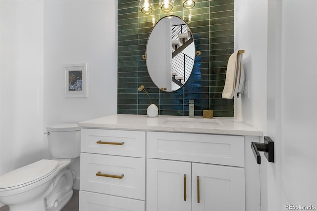 bathroom featuring tile walls, backsplash, vanity, and toilet