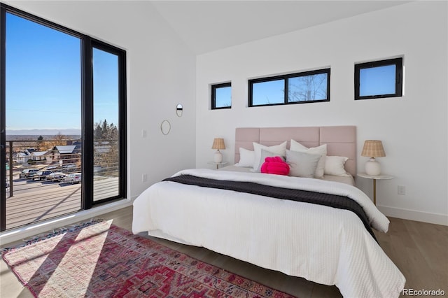 bedroom with dark hardwood / wood-style floors and vaulted ceiling