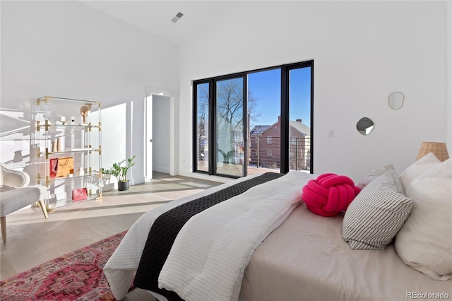 bedroom featuring a high ceiling and a notable chandelier