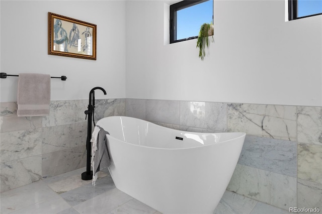 bathroom with tile walls and a washtub