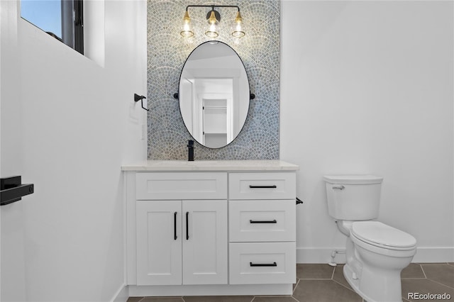 bathroom featuring tile patterned floors, vanity, and toilet