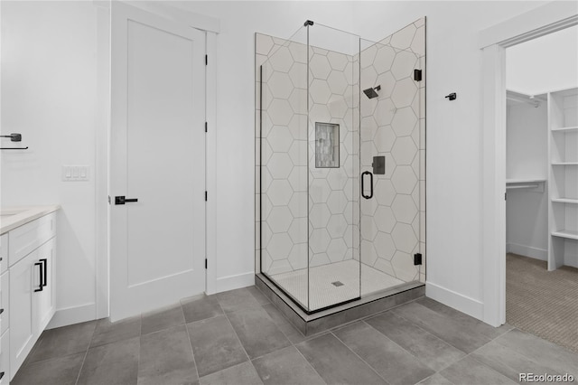 bathroom featuring vanity and a shower with door