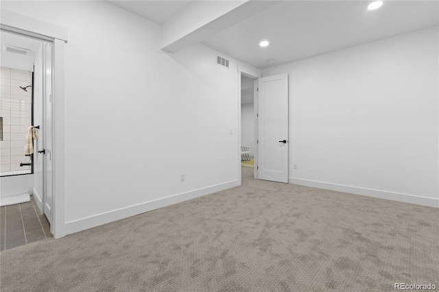 spare room featuring dark colored carpet