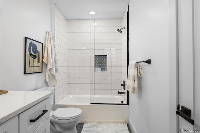 full bathroom with tiled shower / bath, vanity, toilet, and tile patterned floors