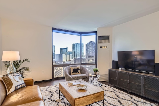 living room featuring a wall of windows and hardwood / wood-style flooring