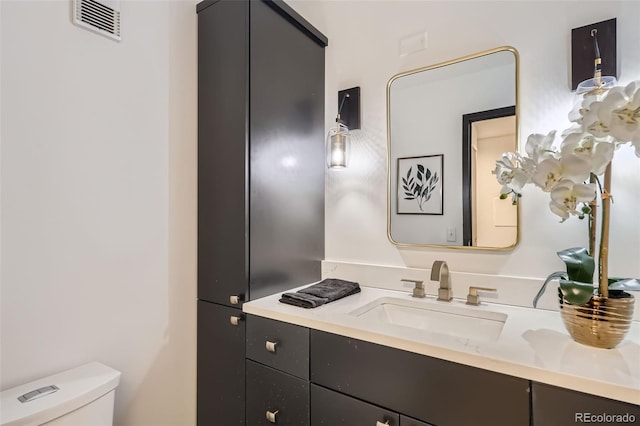 bathroom with toilet and vanity