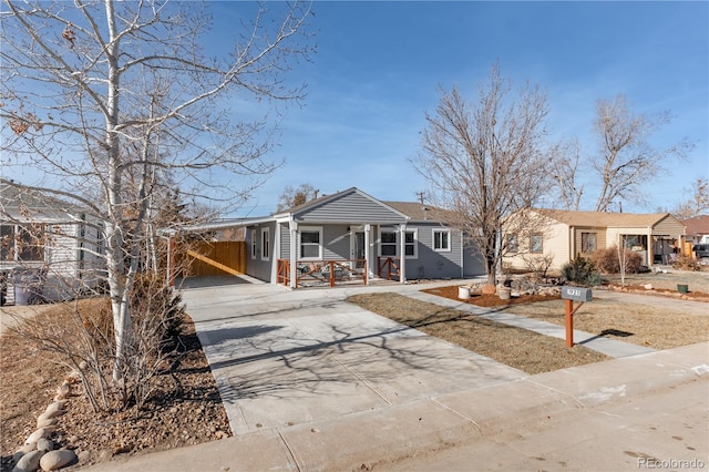 view of front of property with a porch and a carport