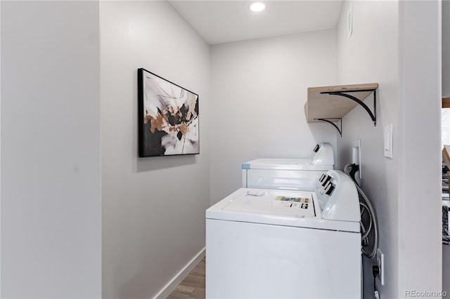 laundry room featuring independent washer and dryer and dark hardwood / wood-style floors