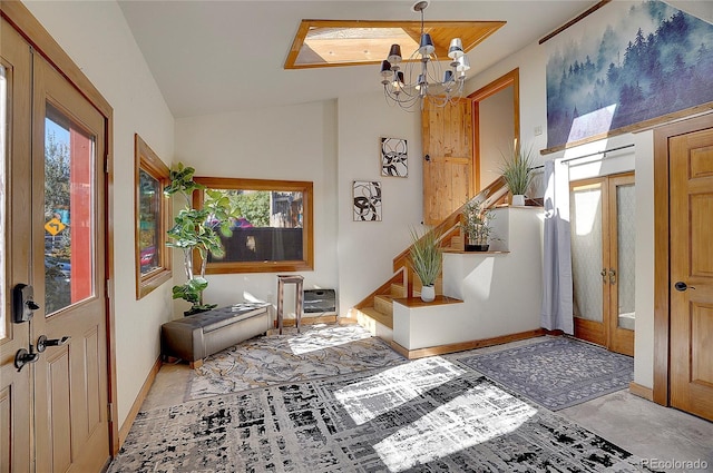 foyer entrance featuring vaulted ceiling and an inviting chandelier