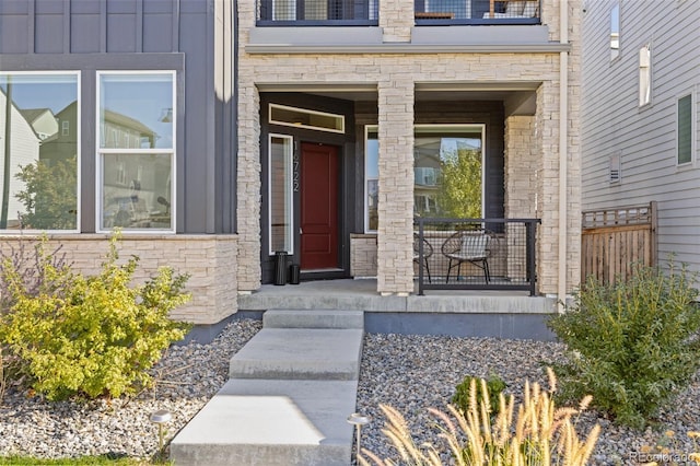 view of exterior entry with covered porch