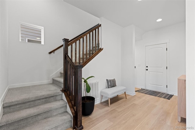 stairs with hardwood / wood-style flooring