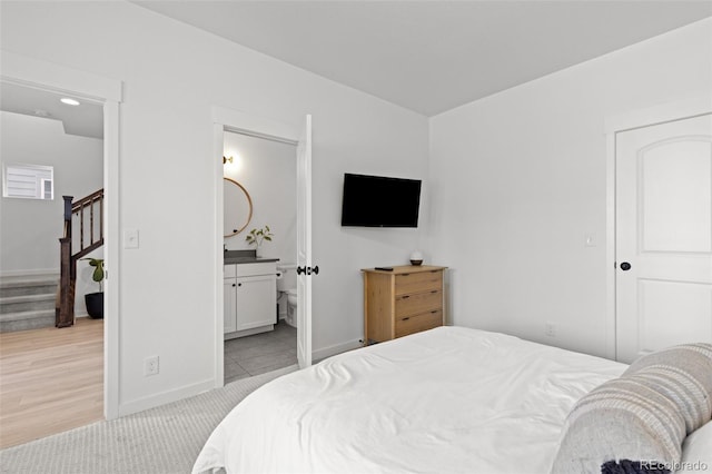 carpeted bedroom featuring connected bathroom