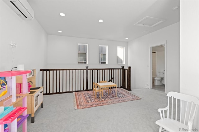 interior space featuring a wall mounted air conditioner and light colored carpet