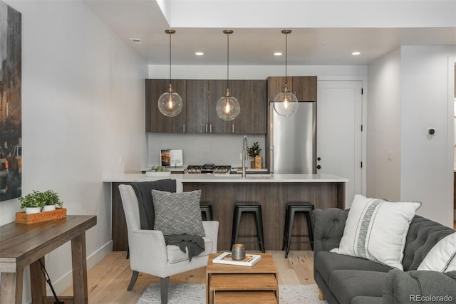 521 21st St, Golden, CO 80401 - kitchen featuring light countertops, light wood-style floors, open floor plan, modern cabinets, and freestanding refrigerator