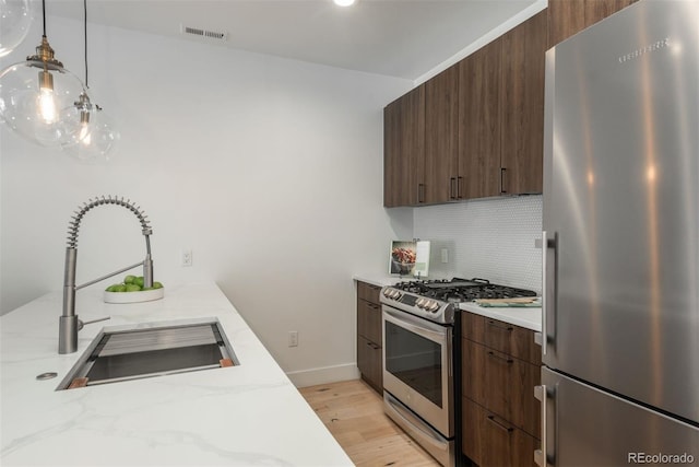 521 21st St, Golden, CO 80401 - kitchen featuring stainless steel appliances, tasteful backsplash, and modern cabinets