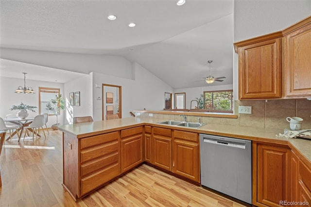 2226 Lily Dr, Loveland, CO 80537 - kitchen with dishwasher, vaulted ceiling, light wood-type flooring, a sink, and light countertops