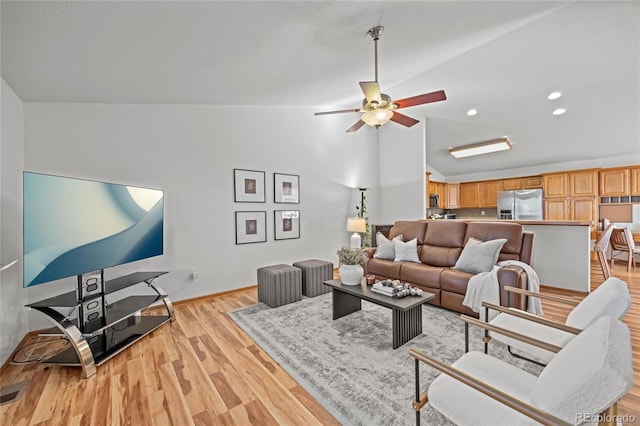 2226 Lily Dr, Loveland, CO 80537 - living area with vaulted ceiling, ceiling fan, light wood finished floors, and recessed lighting