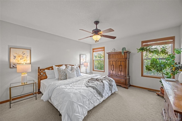 2226 Lily Dr, Loveland, CO 80537 - bedroom with baseboards, light colored carpet, and a ceiling fan