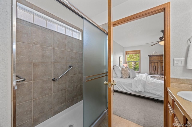 2226 Lily Dr, Loveland, CO 80537 - bathroom featuring connected bathroom, a shower stall, ceiling fan, and vanity