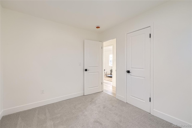 spare room with light colored carpet