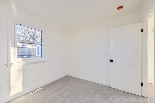 empty room featuring light carpet