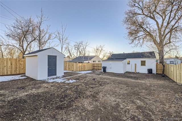 rear view of house with a storage unit