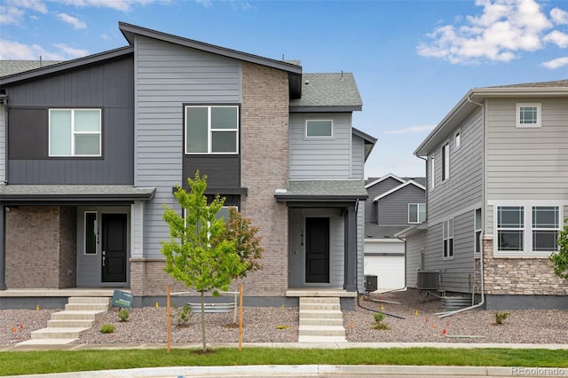 1418 Hudson Pl, Longmont, CO 80501 - contemporary home with an outbuilding, brick siding, and roof with shingles