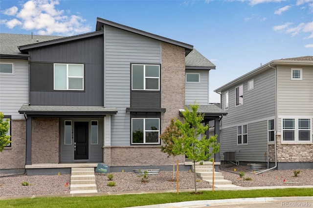 1418 Hudson Pl, Longmont, CO 80501 - view of front facade featuring brick siding and a shingled roof