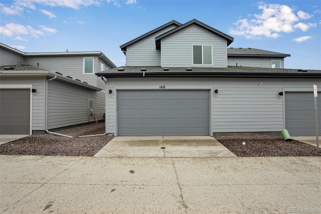 1418 Hudson Pl, Longmont, CO 80501 - view of front of house featuring driveway and a shingled roof