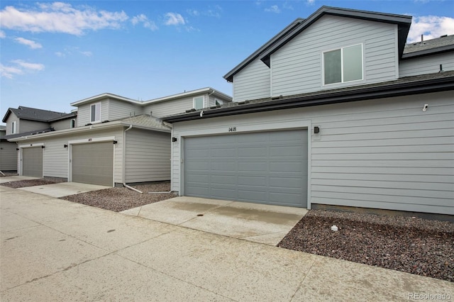 1418 Hudson Pl, Longmont, CO 80501 - view of property exterior featuring driveway and a garage