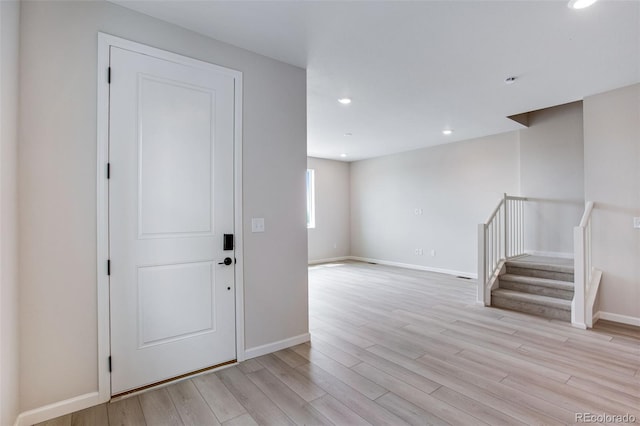 1418 Hudson Pl, Longmont, CO 80501 - entrance foyer featuring light wood-style floors, stairs, and recessed lighting