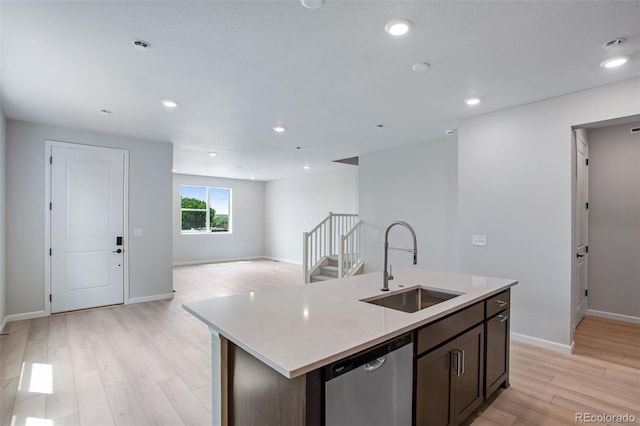 1418 Hudson Pl, Longmont, CO 80501 - kitchen featuring stainless steel dishwasher, light wood-style flooring, dark brown cabinets, an island with sink, and recessed lighting