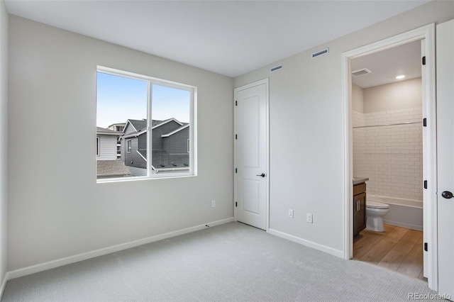 1418 Hudson Pl, Longmont, CO 80501 - unfurnished bedroom with carpet floors and connected bathroom
