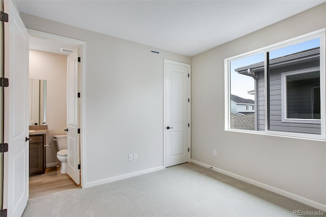 1418 Hudson Pl, Longmont, CO 80501 - unfurnished bedroom featuring carpet flooring and ensuite bathroom