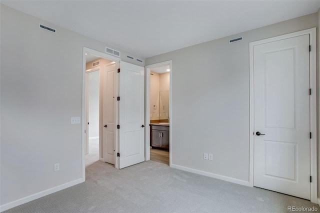 1418 Hudson Pl, Longmont, CO 80501 - unfurnished bedroom featuring light colored carpet and ensuite bath