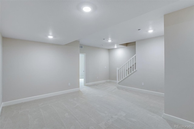 1418 Hudson Pl, Longmont, CO 80501 - finished below grade area with recessed lighting, light carpet, and stairway