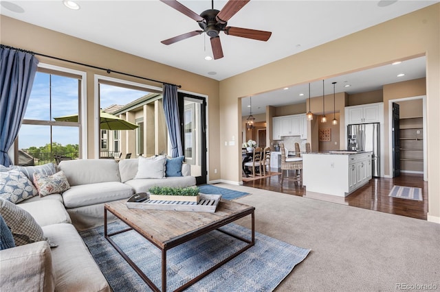 6303 Ellingwood Point Pl, Castle Rock, CO 80108 - living area featuring dark colored carpet, a ceiling fan, and recessed lighting