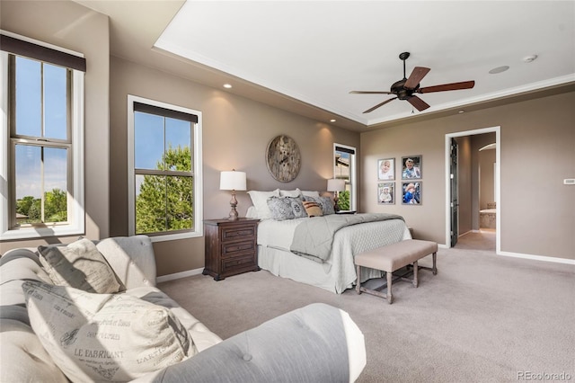 6303 Ellingwood Point Pl, Castle Rock, CO 80108 - bedroom with light carpet, a tray ceiling, ceiling fan, connected bathroom, and recessed lighting