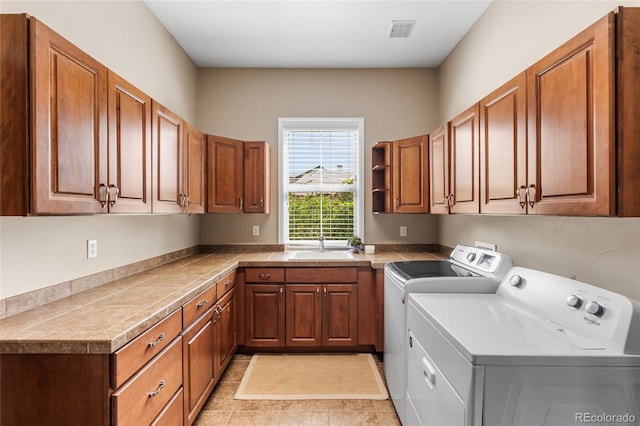 6303 Ellingwood Point Pl, Castle Rock, CO 80108 - laundry area featuring cabinet space, separate washer and dryer, and light tile patterned flooring