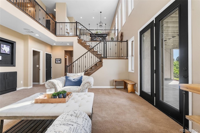 6303 Ellingwood Point Pl, Castle Rock, CO 80108 - living room featuring carpet, stairway, a high ceiling, a chandelier, and recessed lighting