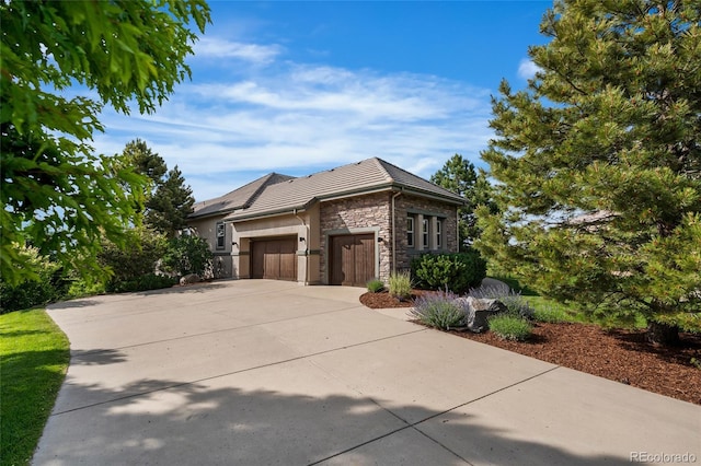 6303 Ellingwood Point Pl, Castle Rock, CO 80108 - view of home's exterior with stone siding, a garage, and concrete driveway