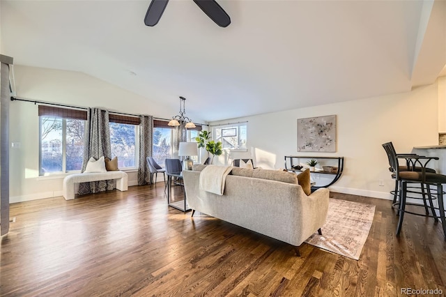 living room with lofted ceiling, dark hardwood / wood-style floors, and ceiling fan with notable chandelier