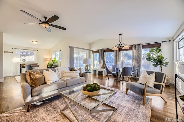 living room with hardwood / wood-style flooring, vaulted ceiling, and ceiling fan