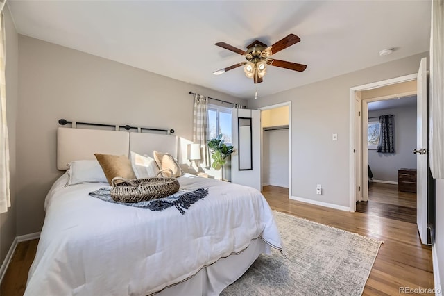 bedroom featuring ceiling fan, wood-type flooring, and a closet