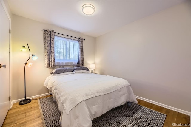 bedroom with hardwood / wood-style floors