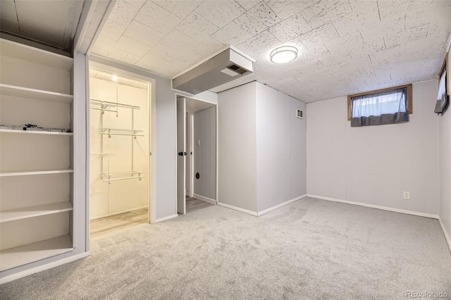 basement featuring light colored carpet