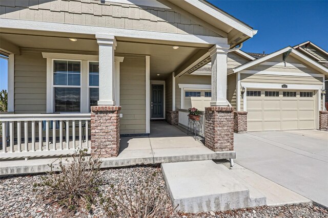 14521 Vancouver Pl, Parker, CO 80134 - doorway to property featuring a porch, an attached garage, and concrete driveway